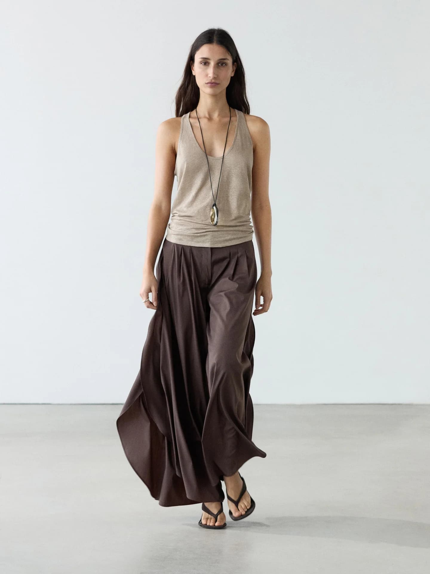 Брюки с широкими штанинами, складками и разрезами по бокам.